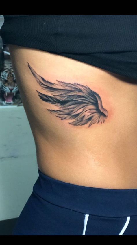 rib-cage-angel-wing-tattoo-angel-and-devil-tattoo-black-top-black-pants Angel Wings Tattoo Small, Wings Tattoo Small, Wing Tattoo On Shoulder, Tattoo Angel Wings, Wing Tattoos On Wrist, Angel Wings Tattoo On Back, Angel Wing Tattoo, Heart With Wings Tattoo, Wing Tattoos On Back