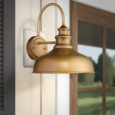 This farmhouse wall light is made of metal construction with gold finish. The gooseneck arm design brings you a simple feeling to your place. Hard wired. Includes all mounting hardware for quick and easy installation. Ideal for barn, warehouse, covered porch, living room, bedroom, kitchen, entryway Finish: Gold | Longshore Tides Azeezah Armed Sconce Metal in Yellow | 13.5 H x 13.1 W x 13.1 D in | Wayfair Farmhouse Wall Lighting, Barn Light Fixtures, Porch Light Fixtures, Farmhouse Wall Sconces, Front Porch Lighting, Classic Wall Lights, Cottage Lighting, Porch Living, Exterior Light Fixtures