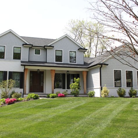 This house has James Hardie Light Mist siding on it with Arctic White trim. The use of straight edge shake siding on the front makes it stand out and look incredible. James Hardie Siding, White Porch, Shake Siding, Hardie Siding, Bungalow Renovation, James Hardie, Siding Colors, White Windows, Exterior Remodel