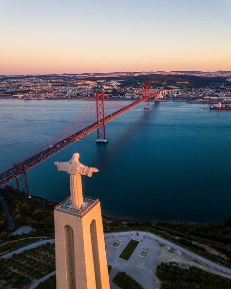 Christ the King and the 25 de Abril bridge. The Ponte 25 de Abril is a massive red suspension bridge in Lisbon, Portugal. It’s often mistaken for the Golden Gate bridge, as they look a lot alike.Want to see it for yourself?This guide has everything you need to know to plan your visit, including the best viewpoint.Let’s jump right in! Golden Gate Bridge Wallpaper, Lisbon Hotel, Portugal Vacation, Christ The King, Travel Destinations Bucket Lists, The Golden Gate Bridge, Visit Portugal, Suspension Bridge, Famous Landmarks