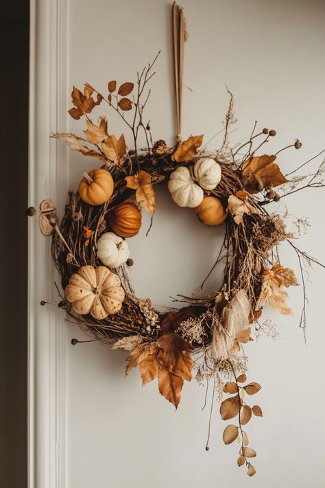 Elegant wreath with small pumpkins and dried leaves for Simple Fall Fireplace Decor. Perfect for cozy and neutral fall indoor home decor.