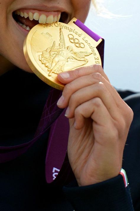 LONDON - AUGUST 04: Jessica Rossi of Italy bites the gold medal on the podium during the medal ceremony for the Women's Trap Shooting Finals on Day 8 of the London 2012 Olympic Game at the Royal Artillery Barracks on August 4, 2012 in London, England. (Photo by Lars Baron/Getty Images) 2012 Getty Images Escuderias F1, Sports Medals, 2012 Summer Olympics, Gymnastics Team, Usa Gymnastics, Olympic Gold Medals, Olympic Medals, Olympic Gymnastics, Artistic Gymnastics