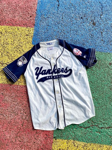 Vintage 90s/2000s New York Yankees MLB Baseball Starter Script Tail Sweep Jersey Size Large        You are viewing a VTG Yankees Jersey     Starter Tag  GOOD Condition Minor cosmetic stains may exist  Cream/Off-White and Blue Jersey! 65% Polyester, 35% Cotton    Measurements: 32" LONG, 23.5" WIDE and 38" SLEEVE-to-SLEEVE  Terms: Vintage clothing sizing varies and may have minor cosmetic imperfections. We recommend measuring one of your favorite pieces to compare! Will ship as soon as possible AFTER receiving payment. Please ask any questions or request more pictures if you have additional concerns. NO RETURNS, sold as is. Yankee Jersey Outfit Woman, 2000s New York, 90s Jersey, Vintage Baseball Jersey, Baseball Jersey Outfit, Yankees Shirt, Yankees Jersey, 90s New York, Jersey Baseball