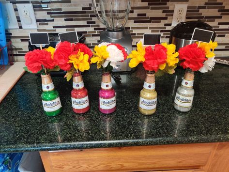 This was so easy to make these are a smaller size beer glass bottles decorated with glitter and fake flowers. Beer Centerpieces, Beer Bottle Centerpieces, Modelo Beer, Mexican Theme Party Decorations, Beer Decorations, Wine Bottle Centerpieces, Mexican Beer, Fiesta Theme Party, Boy Birthday Party Themes