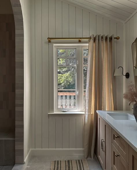 Your morning rituals with an upgrade. ✨ The existing primary ensuite in our client’s home lacked storage, had a cramped shower, and even walls that didn’t reach the ceiling! 😳 This timeless design makes the ensuite feel more spacious and functional with a double vanity, tall vaulted ceilings, shiplap cladding, and an extended shower. . . . . . . . #torontointeriordesigner #architecturaldigest #houseandhome #domino Shower Across From Vanity, Vaulted Ceiling Master Suite, Vaulted Ceiling Bathroom, Bathroom Vaulted Ceiling, Vertical Shiplap Bathroom, Bathroom Wall Paneling, Shiplap Interior, Vertical Shiplap Wall, Primary Ensuite