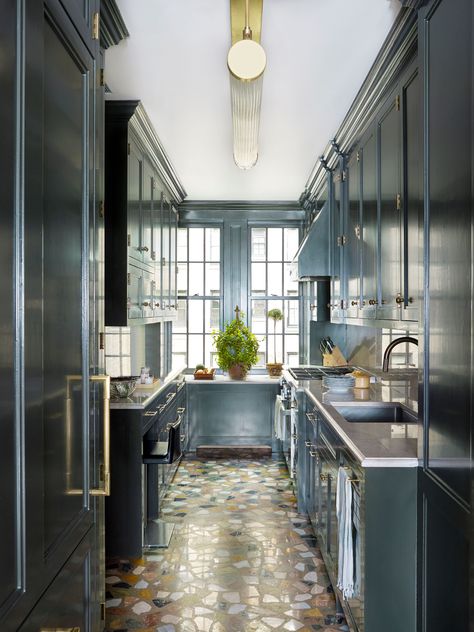 This classic Manhattan galley kitchen is the perfect spot for our slim and streamlined Winston pendant. Its alluring long glass rods and recessed LED panel blend to create a soft and even glow with no discernible light source. Winston shown in polished brass unlacquered finish with clear glass. Interiors by @bunnywilliams_interiordesign. Photography by @francescolagnese.  As seen in The Current, Vol. 2 #athomewiththecurrent #kitchen #pendant #hanginglights #interiordesign #UECoCity New York Townhouse, Bunny Williams Home, Urban Electric, Bunny Williams, Manhattan Apartment, Decorating Advice, Terrazzo Flooring, Galley Kitchen, New York Apartment