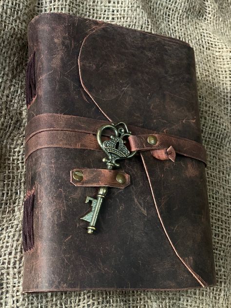 "Beautiful Cow Hide Leather Journals Soft and Durable Dark Brown Genuine Leather Bound With Key,  - No glue used. - Hand Stitched. - Binding diary (paper is not refillable). - Real Leather scent. - Deckle Edge paper - each journal is very special  Size - (length) 7\" x (Hight) 5\" x (width) 2\" inch. A perfect combination of luxurious leather cover and perfect quality paper. OUR DARK BROWN LEATHERBOUND NOTEBOOKS MAKE HEARTWARMING BIRTHDAY, ANNIVERSARY, VALENTINE'S, GRADUATIONS, ENGAGEMENT, WEDDI Brown Diary Aesthetic, Leather Book Aesthetic, Leatherbound Journals, Vintage Notebook Aesthetic, Vintage Accessories Aesthetic, Vintage Diary Cover, Brown Leather Aesthetic, Leather Journal Aesthetic, Vintage Brown Aesthetic