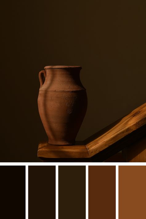 Minimalist composition featuring a rustic clay jug on a wooden surface, set against a dark brown background. The earthy brown color palette emphasizes the natural texture and warmth of the materials. Dark Brown Palette Colour Schemes, Dark Chocolate Brown Color Palette, Brown Color Palette Combination, Brown Color Plattes, Brown And Red Colour Palette, Chocolate Color Palette, Black Red Brown Colour Palette, Dark Brown Color Palette, Colour Palette Brown Earth Tones