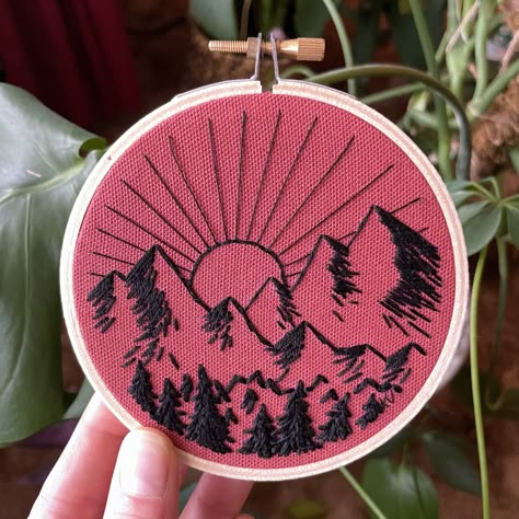 A simple mountain landscape, drawn and embroidered by hand with black thread on rust-colored cotton fabric. Framed in a small 4 inch embroidery hoop. Easy Mountain Embroidery, Mountain Embroidery Designs, Mountain Embroidery Simple, Embroidery Mountains Simple, Mountains Embroidery, Mountain Embroidery, Black Thread, Mountain Landscape, Embroidery Hoop