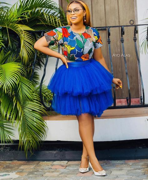 African Trendy Styles on Instagram: “Sunday Blues 💙💙💙 @therealrhonkefella repping in gorgeous Ankara and tulle skirt by @rhonkefellacollections” Ankara Party Dress, African Crop Top, Short Ankara Dress, Ankara Maxi Skirt, Latest Ankara Short Gown, Sunday Blues, Nigerian Fashion Ankara, African Traditional Wear, Ankara Short Gown Styles