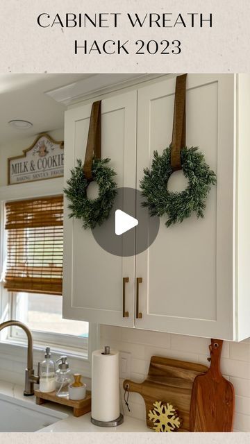 Wreath For Cabinet Doors, Hanging Small Wreaths On Cabinets, Christmas Wreath In Kitchen, Christmas Wreaths Cabinets, Hanging Wreaths With Ribbon, Top Of Cabinets Christmas Decorations, Kitchen Cabinet Door Wreaths, Ribbon Hanging Wreath, Christmas Wreath On Cabinet Door