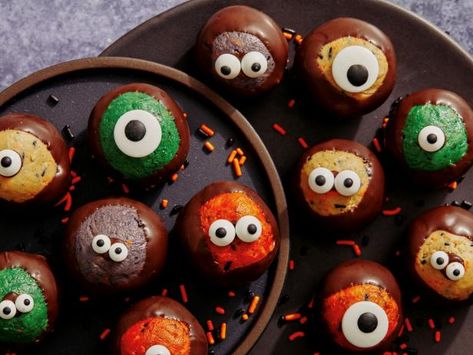 Get Halloween Buckeyes Recipe from Food Network Food Network Buckeyes, Halloween Buckeye Balls, Halloween Buckeyes Recipe, Halloween Buckeyes, Buckeye Recipe, Fun Halloween Desserts, Halloween Potluck, Buckeyes Recipe, Candy Eyeballs