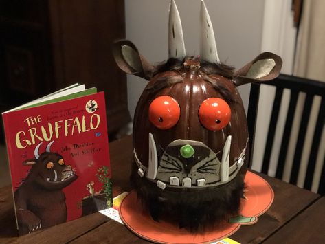 The Gruffalo book character pumpkin for my daughters 3rd grade class.  I used a fake pumpkin, spray painted it, and cut an ornament in half and painted the eyes. Foam teeth, fake fur hair, felt ears/muzzle, horns are modified paper mache cones.  Embellished with sparkle glitter paint.  All from Michaels. Book Characters Pumpkin, Pumpkin Painting Book Characters, Gruffalo Pumpkin, Book Character Pumpkins For Kids, Gruffalo Book, The Gruffalo Book, Book Character Pumpkin, Gruffalo Characters, Pumpkin Spray