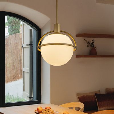 This minimalist pendant light seamlessly blends modern and vintage charm. Its centerpiece is a 20cm (7.87-inch) frosted milk-white globe, surrounded halfway by metal rings, creating an illusion of suspension. This design visually enriches the space, as the collision between the milk-white glass globe and the metal elements generates a subtle yet elegant ambiance, enhancing its visual appeal. Compatible with E26 sockets, the lampshade diffuses a soft, gentle light, providing just the right amount Brass Entry Light Fixture, Entry Light Fixture, Dark Academia Bedroom, Milk Glass Pendant, Minimalist Pendant Light, Milk Glass Pendant Light, Academia Bedroom, Entry Lighting, Minimalist Pendant