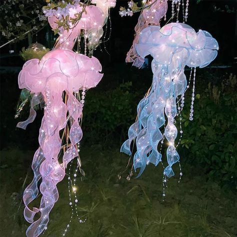 pink and blue jellyfish lanterns at night, hanging from a pink flowering tree Lantern Fairy Lights, Diy Jellyfish Decoration, Jellyfish Lights, Jellyfish Haircut, Jellyfish Tentacles, Hanging Jellyfish, Jellyfish Lantern, Diy Jellyfish, Jellyfish Decorations