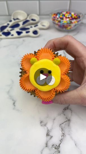 2.7M views · 41K reactions | 🦁🧡 Lion cupcakes 💛🦁 Guys, let’s make a cupcake zoo together 🧁 Starting with the king of the jungle 🦁🧁 Which animal should we add next? 🦁 Use an open star piping tip and orange buttercream to pipe dots around the edge of the cupcakes. 🦁 Using the pipe and swipe technique, spread the dots into the centre, using a small piping tip. 🦁 Use a round piping tip to add a large dollop of yellow buttercream to the middle of the cupcake. Smooth it with a spatula.🦁 Add two yellow mini M and Ms for ears and a heart sprinkle for the nose.🦁 Add two white fondant circles for the cheeks, using a toothpick to add dots. 🦁 Use two black sprinkles for his eyes. #cupcake #cupcakedecorating #animalcupcakes #cakedbyrach #tutorial | Caked By Rach | Jungle · I've Been In Lov Lion Cupcake Cake, Safari Animal Cupcakes, Open Star Piping Tip, Star Piping Tip, Zoo Animal Cupcakes, Tiger Cupcakes, M And Ms, Lion Cupcakes, Specialty Cupcakes