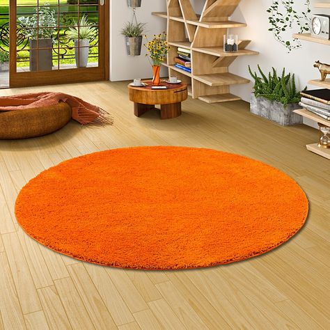 The product is a modern high pile long pile carpet with a unique and particularly fluffy pile. The carpet is ideal for all living areas and gives every room a distinctive ambiance. Due to the excellent quality, the pile is easy to clean and easy to vacuum. Rug Size: Round 100cm Carpet Orange, Orange Carpet, Circular Rugs, Shaggy Rug, Perfect Rug, Orange Rugs, Wool Carpet, Ebern Designs, Living Area