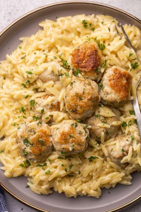 "An enticing image featuring Chicken Meatballs served on a bed of creamy Garlic Parmesan Orzo, a flavorful and comforting dish." Crockpot Garlic Butter Chicken Meatballs With Orzo, Chicken Meatballs And Risotto, Chicken Meatball Gnocchi, Swedish Meatball Orzo, Chicken Meatballs And Gnocchi, Instant Pot Chicken Meatballs, What To Make With Chicken Meatballs, Garlic Parmesan Chicken Meatballs, Store Bought Meals