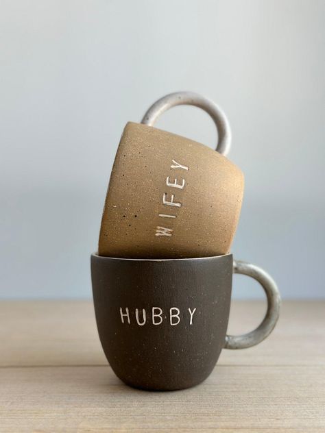 These handmade Hubby & Wifey Mugs make the perfect gift to personalize for any couple! Crafted with love, you can choose from a variety of colors to make these ceramic mugs totally unique. Perfect for celebrating anniversaries, weddings ,house warmings or Christmas ☺️ Listing price is for a pair lovingly set in natural wood gift box and includes 4 seasonal teabags Listing price is per mug or for pair MEASURES :approx. 4" wide x 4" tall - Holds approximately 16oz Why You’ll Love It Dishwasher & M Big Mug, Wood Gift Box, Couple Mugs, Getting A Puppy, Mugs For Men, Cottage Interiors, Crystal Lake, Makes You Beautiful, Pottery Pieces