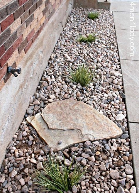 Gravel around the foundation for drainage, plant shrubs along to help soak up water. Like the idea of the large rock to prevent erosion from the water spicket. Maybe a few cool pots or barrels with plants too? I like :) Hose Bib Ideas, Curb Appeal Without Plants, House Border Landscape, Gravel Flower Bed Ideas, Foundation Landscaping Ideas, Rock Flower Beds In Front Of House, Rock Beds Around House, Cottage Patio, Bed Idea