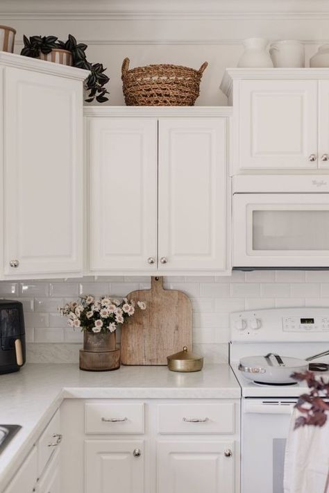 How to Decorate Above Your Kitchen Cabinets - Decoholic Decorate Top Of Kitchen Cabinets, Decorate Above Kitchen Cabinets, Top Of Cabinet Decor, Above Cabinet Decor, Space Above Kitchen Cabinets, Spring Kitchen Decor, Top Kitchen Cabinets, Top Of Kitchen Cabinets, Decorating Above Kitchen Cabinets