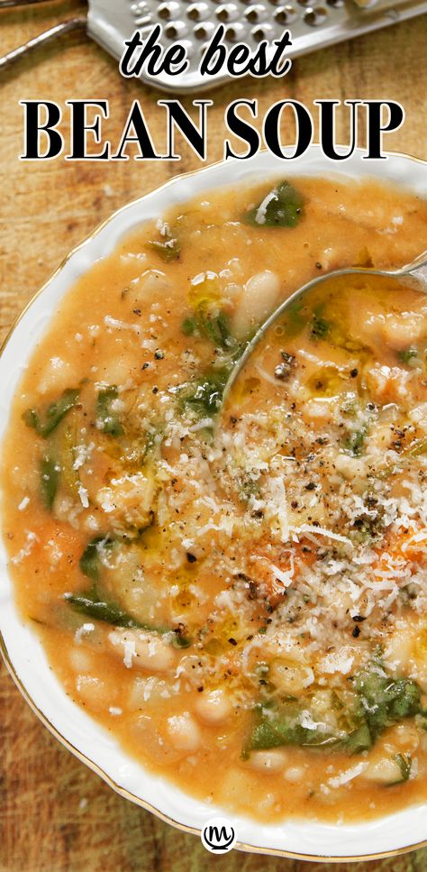 Top view of a white bowl full of white bean soup over a wooden background. Best Bean Soup Ever, Creamy White Bean Soup With Kale, White Bean And Lentil Soup, Portuguese White Bean Soup, Cajun White Bean Soup, Soup Recipes Bean, Northern White Bean Soup, Pork And White Bean Soup, The Best White Bean Soup