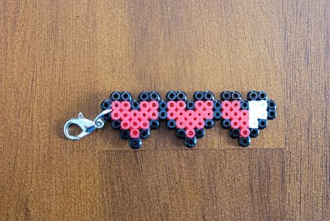 "Life Hearts Mini Perler Beads Keychain/Pendant Just to be clear this item is made from Mini Beads, not regular beads. It has a lobster claw connected to attach to a keychain, necklace, backpack, etc. Size is 5\" x 2\" Great gift idea and stocking stuffer! This item comes with tracked shipping. This item is made by placing bead by bead, or pixel by pixel on a pegboard. The beads are then melted together by ironing one side together to create the finished product. Not seeing the design you like? Perler Bead Phone Charms, Perler Bead Pentagram, Things To Make Out Of Iron Beads, Peeler Bead Small Ideas, Minecraft Iron Beads, Melty Bead Keychain, Perler Bead Matching, Mini Fuse Beads, Iron Beads Keychain