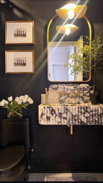 Alexandra Levy on Instagram: "This may be controversial, but designing with dark/moody colors in small spaces is probably my favorite! If you’re like me, and drawn to bold and beautiful colors, small spaces are a great way to express yourself without getting overwhelmed. 🥰

So happy this guest bathroom is finally complete and couldn’t be happier with the outcome! Huge shoutout to @hmmarblestone for this incredible marble sink that is a complete show stopper! 😍 

Comment shop for product info and check out my LTK in bio.✨
.
.
Bathroom
Neutral home
Luxe home
Modern organic 
Neutral aesthetic
.
.
#bathroom #beforeandafter #ltk #ltkhome #homefinds #homedetails #homedesign #homedesignideas #luxurydesign #luxurydesigner #bolddesign #glamdecor #neutralhome #neutraldecor #luxeinteriors #luxestyl Moody Powder Bath, Modern Half Bath, Bathroom Neutral, Bar Remodel, Sink Backsplash, Backsplash Marble, Organic Bathroom, Moody Colors, Calacatta Viola