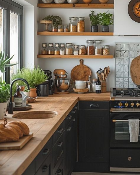 🖤 Dark Boho Kitchen Dreams: Where Edgar Allan Poe Meets Morticia Addams 🍳 Transforming my tiny kitchen into a moody culinary wonderland! Picture this: * Dramatic black cabinets with gleaming brass accents * Classic New York subway tiles for that urban edge * Open shelves showcasing my eclectic collection - glass skulls rubbing elbows with vintage lab beakers 🧪💀 * Shimmering copper pots ready for witchy brews (or just really good pasta) * Lush greenery breathing life into every corner 🌿 It’s a... Black Kitchen Brown Countertop, Moody Retro Kitchen, Moody Boho Kitchen, Small Kitchen Black Cabinets, Dark Boho Kitchen, Dark And Moody Kitchen, Masculine Kitchen, Light Goth, Brown Countertop