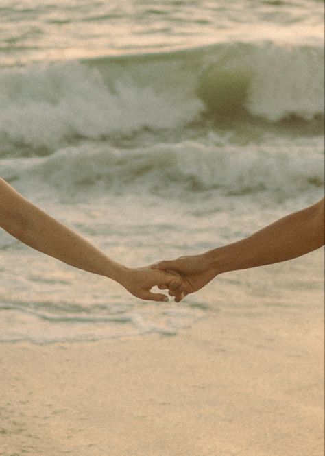 Couple holding hands at the beach #warmandfuzzy #couplesphotoshoot #engagement Aesthetic Lovers Picture, Perfect Life Pictures, Couple Photo At Beach, Couple On Beach Aesthetic, Love Beach Aesthetic, Aesthetic Hand Holding, Love Languages Aesthetic, Connection Aesthetic, Holding Hands Painting