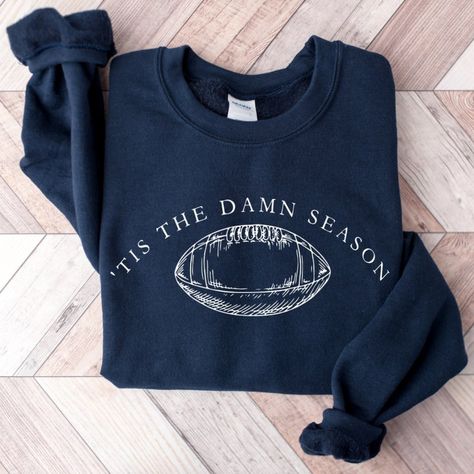 Tis The Damn Season Football Sweatshirt College Football Game Day Get Ready For Game Day With The Tis The Damn Season Football Sweatshirt And Hoodie! Perfect For College Football Fans, This Cozy Sweatshirt And Hoodie Combo Is Designed To Keep You Warm And Stylish While Cheering For Your Favorite Team. Whether You’re Tailgating Or Watching From The Stands, This Is The Ultimate Gear For Any Football Season. Fun Football Design: Features A Bold “Tis The Damn Season” Graphic, Perfect For Showing Off Tis The Damn Season, Football Spirit, College Football Games, Football Sweatshirt, Football Design, Game Day Shirts, Football Game, Cozy Sweatshirts, Football Season