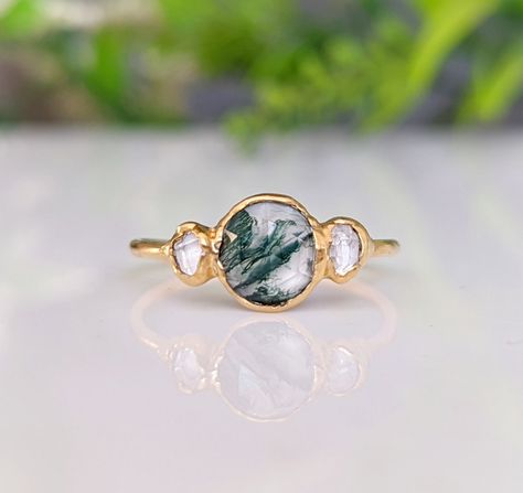 CUT-OFF DATE TO RECEIVE YOUR ORDER BY CHRISTMAS: Sunday December 10th, 2023 All orders received AFTER December 10th will be created and shipped after the Christmas Holidays. Unlock a world of timeless beauty with our Moss Agate and Herkimer diamond engagement ring. Our Nature-inspired Engagement ring features an organic green Moss Agate nestled between 2 sparkly raw Herkimer diamonds and uniquely set on a 14k Gold band. A one-of-a-kind rustic piece that will showcase the natural beauty of love a Herkimer Diamond Engagement Ring, Herkimer Diamond Ring Engagement, Ring Moss Agate, Moss Agate Jewelry, Unique Promise Rings, Raw Diamond Engagement Rings, Nature Inspired Engagement Ring, Herkimer Diamond Ring, Raw Crystal Ring