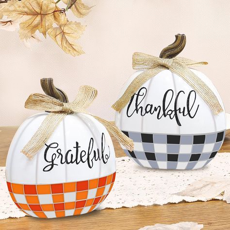 PRICES MAY VARY. Resin 2 Pack Tabletop Fall Pumpkin Decor: The package includes 2 plaid bow designed fall pumpkin decor, each measuring 5in L*3in W*6in H, decorated with bows and engraved with the words "Thankful" and "Grateful." Suitable for fall home decor Classic Plaid Bow Fake Pumpkins: resin material; buffalo plaid design, one in classic black, white and gray, the other in vibrant red, orange, and white. Linen bows add a rustic charm to the overall look Lightweight & Sturdy Thanksgiving Dec Thanksgiving Dec, Thanksgiving Crafts Decorations, Resin Pumpkin, Table Centerpieces For Home, Fall Pumpkin Decor, Fake Pumpkins, Plastic Pumpkins, Artificial Pumpkins, Pumpkin Thanksgiving