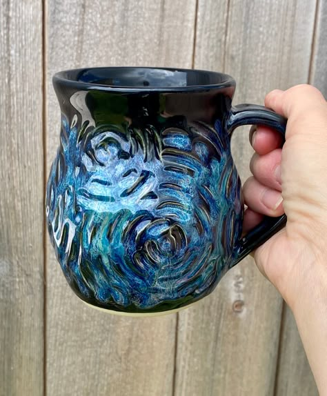 "Please note my turnaround time is 4-6 weeks. Please contact me if you need an item sooner and I can let you know when my next kiln firing will be. All pieces unless otherwise noted are made to order Made to order beautiful hand carved and sculpted pottery coffee mug holds approximately 14 - 16 oz. This glaze combination is called dragon. This listing is for ONE coffee mug. Each piece if pottery is shaped by hand out of high fire clay, then carved by hand, glazed, and fired to cone 6 which is 22 Mugs To Make Out Of Clay, Cool Glaze Combinations, Coffee Mug Handmade, Cool Mug Designs Ceramics, Ceramic Wheel Throwing, Homemade Ceramic Mugs, Pottery Glaze Designs, Glaze Designs Ceramics, Pottery Mug Shapes