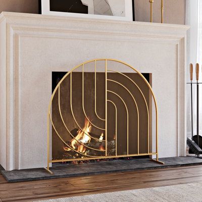 Elevate your home's decor and safety with this elegant gold fireplace screen. Crafted from metal, this screen features a unique arch shape that seamlessly combines style with functionality. The striking design makes it a standout piece in your living space, adding a touch of sophistication to your fireplace area. Designed with safety in mind, this fireplace screen helps keep sparks and embers safely contained, ensuring the well-being of your loved ones. Its single-panel design provides easy acce Mid Century Fireplace Mantle, Glam Fireplace, Mid Century Fireplace Makeover, Gold Fireplace Screen, Modern Fireplace Screen, Mid Century Modern Fireplace, Mid Century Fireplace, Panel Fireplace, Decorative Fireplace Screens