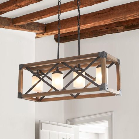 Rectangle Frame  No Bulb Included  Wood + Cast Iron Color Finish  4 Light Sockets  40 Watt  UL Listed  E26/E27 Bulb Socket 
 Description 
 Create a cozy and comfortable home atmosphere with this farmhouse wooden rectangle box pendant light. An open wood frame gives this rectangle pendant a rustic appeal and allows it to breathe in your home, while a warm wood finish accentuates its rustic vibes. Completing the design, four 40W E26 bulbs (not included) glow from within. This farmhouse wooden rect Farmhouse Dining Room Chandelier, Linear Kitchen Island Lighting, Metal Kitchen Island, Modern Farmhouse Chandelier, Rectangular Chandelier, Wood Kitchen Island, Farmhouse Light Fixtures, Kitchen Island Linear Pendant, Wooden Light