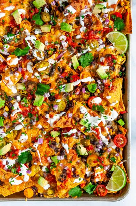 Loaded Vegetarian Sheet Pan Nachos - No superbowl sunday is complete without these crowd pleasing nachos that are done in just 20 minutes . From aberdeenskitchen.com #loaded #vegetarian #sheetpan #nachos #blackbean #corn #mexican #snack #appetizer #recipe #gameday #tailgate Nachos Recipe Vegetarian, Vegetarian Sheet Pan, Vegetarian Nachos Recipe, Loaded Nachos Recipe, Veggie Nachos, Steak Nachos, Sheet Pan Nachos, Pan Nachos, Vegetarian Nachos