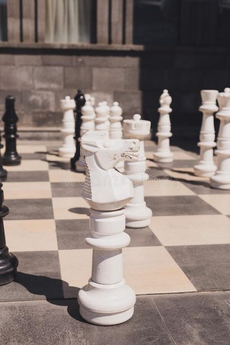 Giant chess on board located on ground outdoor - intellectual game stock image Outdoor Chess Board, Giant Chess Board, Outdoor Chess, Intellectual Games, Giant Chess, Game Image, Black Ground, Outdoor Games, On The Ground