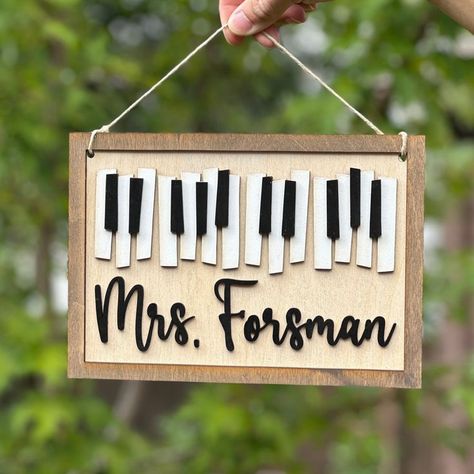 Thank you for checking out my music teacher door hanger listing. This custom music teacher classroom decor sign is not too big and not too small. It is 10 inches wide by 7 inches tall. Personalize your music teacher name sign with your name or gift one of these signs to your music teacher. This sign would make the perfect teacher appreciation gift for your music teacher or piano teacher. Use the sign as a door hanger, wall art, hang it in your music office, etc. Each sign is laser cut from Choir Teacher Gifts Diy, Music Themed Classroom Door, Music Teacher Door Hanger, Chorus Teacher Gifts, Gift Ideas For Music Teachers, Gifts For Piano Teacher, Music Teacher Gifts Diy, Gift For Music Teacher, Music Teacher Gift Ideas