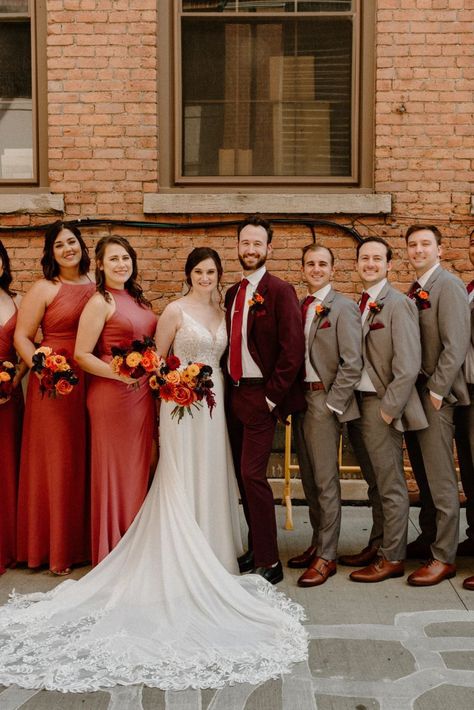 The most important thing about your wedding attire is that you're comfortable... Confidence and comfort show in your photos! You won't be tugging at your attire all day, and you'll exude confidence because you know you look good. Red And Orange Wedding Groomsmen, Maroon Suit Wedding Party, Men’s Burgundy Suit Outfit, Maroon And Brown Wedding, Burgundy Groomsmen Attire Fall Wedding, Burgundy And Tan Wedding Party, Gray And Burnt Orange Wedding, Fall Color Wedding Party, Brown And Burgundy Wedding