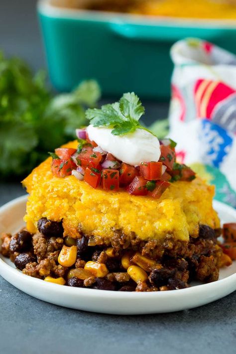 This tamale pie is seasoned ground beef, corn and beans baked together with cheddar cornbread to make a hearty and comforting casserole. Easy Tamale Pie, Beef Tamale Pie, Cornbread Dishes, Easy Tamales, Beans Baked, Corn And Beans, Tamale Pie Recipe, Cheddar Cornbread, Seasoned Ground Beef