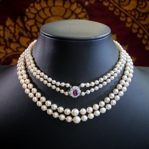 Friday Feature✨ What's better than a strand of gorgeous pearls? Two strands!🤍 A grand Art Deco Pearl Necklace featuring two strands of lovely lustrous Cultured Pearls which graduate in size towards the bottom. The piece is held together by a stunning 18ct White Gold box clasp converted from a ring face. It’s decorated with glistening Brilliant cut Diamonds and two emerald cuts with a gorgeous deep cherry pink Ruby in the centre which is certified as a natural Ruby of Thailand or East Afric... Pearl And Ruby Necklace, Formal Jewellery, Fine Pearl Jewelry, Pearl Clasp, Formal Jewelry, Pink Pearls, Pink Ruby, Ruby Necklace, Gold Box