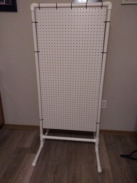 Cost roughly $35 to put together. 2x4 pegboard, pvc pipe, pvc t's, pvc elbows and zip ties is all you need to recreate this. Pvc Display Stand Craft Booths, Pvc Vendor Display, Free Standing Pegboard Display Diy, Craft Booth Pegboard Display, Tier Display Stand Diy, Pvc Organization Ideas, Craft Fair Pegboard Display, Peg Board Display Stand, Pvc Pegboard Display