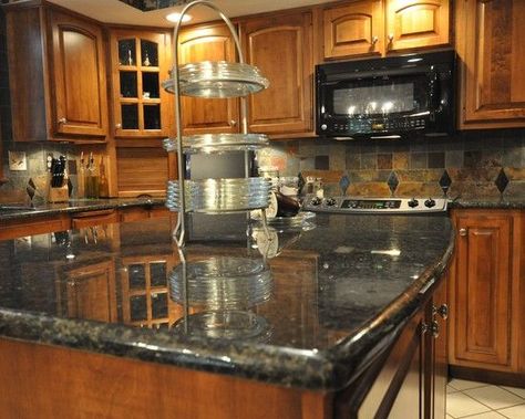 These cupboards are similar to the last but without the rustic look alongside and they look great with the black granite topper without an outdoorsy feel. Plus it ties in well with the tiles on the backsplash. Uba Tuba Granite, Backsplash Herringbone, Replacing Kitchen Countertops, Kitchen Remodel Countertops, Countertop Backsplash, Outdoor Kitchen Countertops, Dark Countertops, Black Granite Countertops, Kitchen Countertop Materials