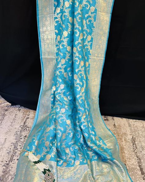 Embrace ethereal elegance with our Sky Blue Katan Silk Saree adorned with lustrous gold zari. Crafted with the finest Katan silk, this saree exudes a subtle charm that is both modern and timeless. The sky blue hue is a refreshing departure from traditional shades, offering a contemporary twist to the classic Banarasi aesthetic. Shop now: https://thechictale.com/products/banarasi-pure-mulberry-katan-silk-saree-with-gold-zari-blue #handwoven #thechictale #loveforsaree #thechictale🥻 #banarsi... Ethereal Elegance, Banarsi Saree, Katan Silk Saree, Aesthetic Shop, Saree Trends, Katan Silk, Saree Styles, Blue Hues, The Chic