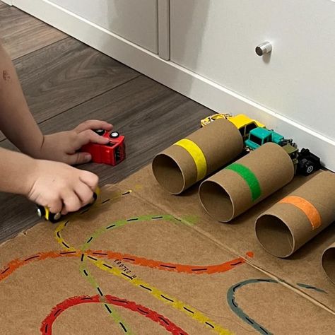 Desiree Blanchard, M.H.K | Baby & Toddler Play on Instagram: "🛑👀STOP THE SCROLL IF YOU LOVE A SIMPLE DIY ACTIVITY! Click the ✨FOLLOW✨ button to continue learning more! To recreate this activity, use TP rolls to make the “garages,” add coloured tape (or marker) on each roll and then tape them flat to a piece of cardboard. We like to use two-way tape for this. Add corresponding “roads” using markers and find small matching coloured cars. That’s it! Have fun! 🫶🏻 ➡️For more, check out my Baby and Toddler Caregiver Play & Milestone guides. It’s loaded with tips, milestones & play ideas! 🔗 in bio • • • #momssupportingmoms #newmomsupport #momoflittles #babysfirstyear #grossmotordevelopment #babydevelopment #babymilestones #mommyandmetime #tummytimefun #newmomsupport #momoflittles #grossmotor Things With Wheels Activities, Car Sensory Activities, Cars Crafts For Toddlers, Car Toddler Activities, Cars Eyfs Activities, Preschool Wheels Activities, Road Safety Activities For Toddlers, Cars Activities For Toddlers, Vehicle Activities For Toddlers