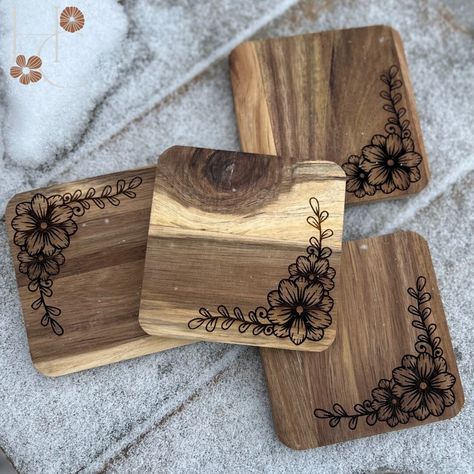 "Introducing our exquisite Acacia Wood Floral Coasters, the perfect addition to elevate any home decor. This set features coasters, meticulously engraved onto real wood, allowing you to choose from two captivating floral patterns that suit your personal style. Measuring at a roughly 4\" x 4\", each coaster showcases the natural variations in color and grain of the acacia wood, resulting in a truly unique and one-of-a-kind piece. As a result, the depth of color in the engravings may vary, adding to the charm and individuality of each coaster. For those seeking an alternative option, we also offer these stunning coasters in slate. Please note that the slate coasters have a rough edge, which may result in some chipping over time. This natural wear and tear only adds to the authentic and rusti Wooden Engraved Coasters, Coaster Wood Burning, Wood Burning Coasters, Wood Burned Coasters, Log Art, Engraved Wood Coasters, Pyrography Ideas, Glowforge Projects, Floral Coasters