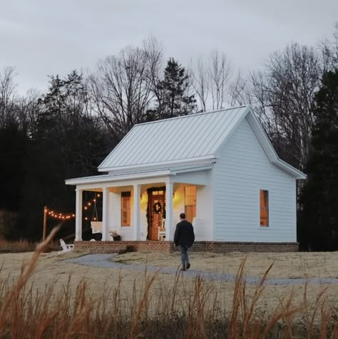 This charming ‘tiny farmhouse’ is under 500 sq. ft and perfect for an older couple Country Style Tiny House, Tiny Modern Farmhouse Exterior, 500 Sq Ft Cottage, Country Farmhouse Tiny House, Small House Plans Under 800 Sq Ft Tiny Homes, Tiny White House, Barndo Tiny Home, Small Home On Land, House Plans Under 500 Sq Ft