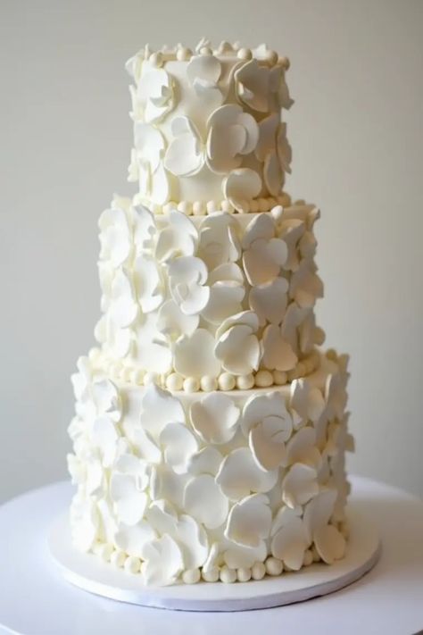 Looking for the perfect white wedding cake to dazzle your guests? Explore our collection of 19 stunning white wedding cake ideas that are sure to turn heads! Whether you're leaning towards a classic design, a towering tiered cake adorned with all-white petals, or a chic and modern creation, we've got inspiration that fits every bride's style. From intricate lace details to minimalist glamour, each cake tells a unique story. Start planning your dream wedding with these fabulous cake ideas that will sweeten your celebration! Elegant Floral Wedding Cake, 6 Tier Cake, White Wedding Cake Ideas, Elegant White Wedding Cake, Wedding Cake Designs Elegant, Elegant White Wedding, Winter Wedding Centerpieces, Simple Wedding Centerpieces, White Weddings