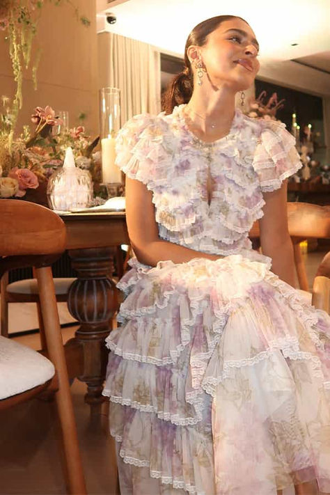 The Wisteria Ruffle Lace Ballerina Dress in Moonshine. This ballerina dress is inspired by an early 1900s hand-painted upholstery design. Beautifully printed with large wisteria florals in soft, muted tones, creating a statement design. This dress is adorned with tulle frills in a zig-zag patten, creating a romantic texture. Crafted with lace trims on the edge of each frill and a keyhole neckline for intricate signature Needle & Thread detailing. Painted Upholstery, Upholstery Design, Ballerina Dress, Keyhole Neckline, Muted Tones, Needle Thread, Lace Trims, Floral Ruffle, Early 1900s